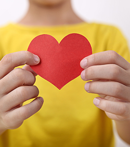 Student holding up a paper heart