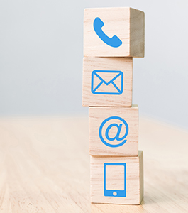 Telephone, smartphone, mail and at icons on blocks