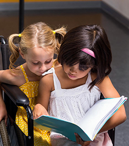 Two female students reading together