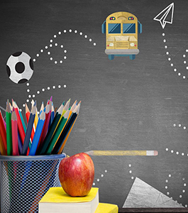 School bus, soccer ball, paper, pencil and paper plane on a blackboard behind colored pencils and an apple stacked on top of books